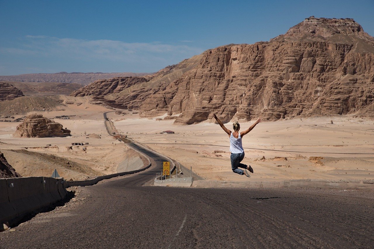 woman, jump, desert, jumping woman, road, street, badlands, barren, nature, barren landscape, freedom, happy, joy, summer, egypt, dahab, sky, landscape, mountains, rocky mountains