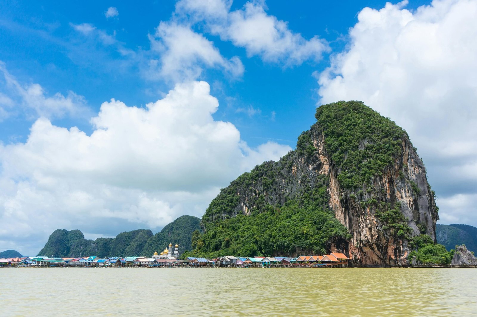 Picturesque seascape in Phang Nga Bay, Thailand featuring dramatic limestone cliffs and serene waters.